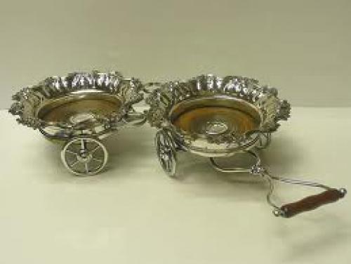 A decorative antique silver plated decanter waggon with articulated movement 